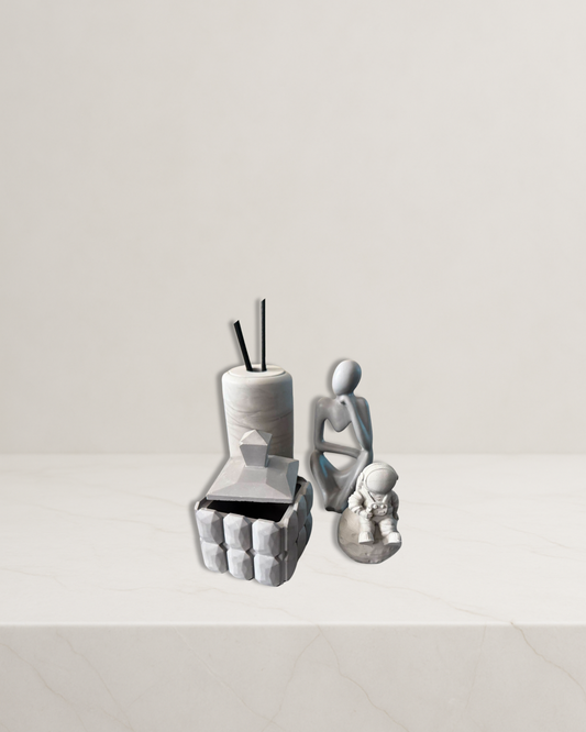 Main: Luxury grey home decor set—reed diffuser, lidded candle holder, Thinker statue, Astronaut figurine

Diffuser close-up: Grey marble-effect reed diffuser—handmade decorative accent

Candle holder close-up: Geometric grey candle holder with lid—modern decor

Thinker statue: Minimalist grey Thinker statue—decorative figurine

Astronaut figurine: Grey Astronaut figurine—playful modern home decor

Lifestyle on shelf: Modern grey decorative set styled on shelf—minimalist interior